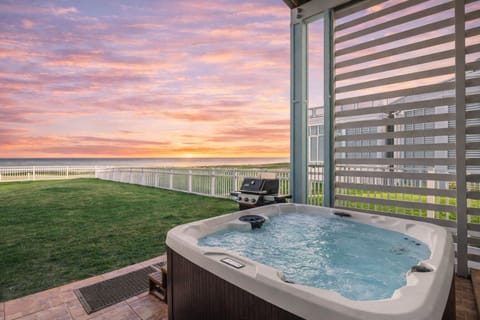 Private outdoor hot tub with ocean views at this Galveston beachfront rental, perfect for relaxing after a day at the beach.