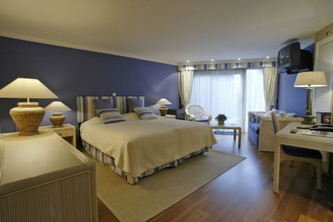 Unwind in a spacious room with cozy seating and soft light.