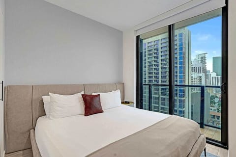 King bedroom with floor-to-ceiling city views