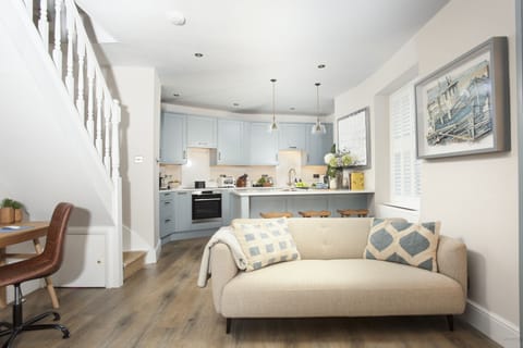 Open plan living, sofa, kitchen and work space - Myrtle Cottage