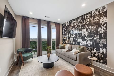Music-inspired living room with iconic musician wallpaper and a pullout queen sofa for additional sleeping space.