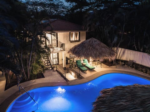 Evening lights transform the courtyard into a tropical sanctuary.