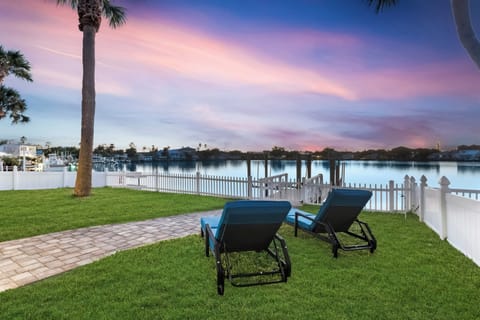 Sunset waterfront welcome with lounge chairs.