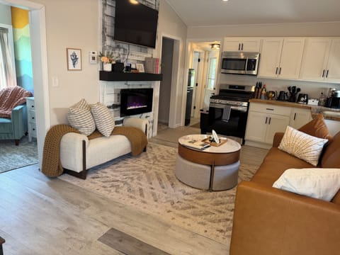 Bright, thoughtfully designed living space with fireplace and fully equipped kitchen.