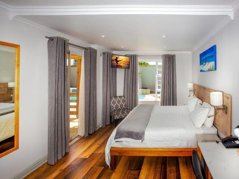 Luxury Double Room, Patio, Partial Ocean View | In-room safe, desk, blackout drapes, iron/ironing board