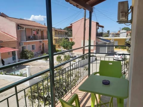 Sunny private balcony with neighborhood views and outdoor seating