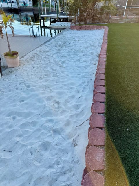 Private sandy beach area with waterfront views and boat dock access for your perfect coastal getaway.