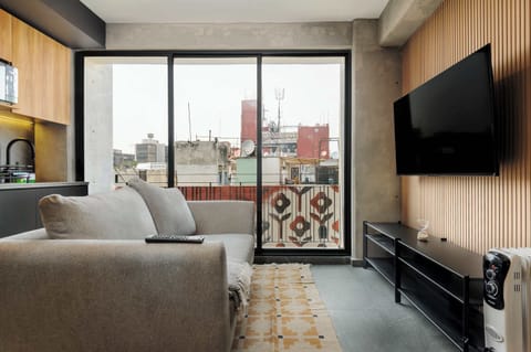 Bright living area with private balcony, perfect for relaxing after a day out.