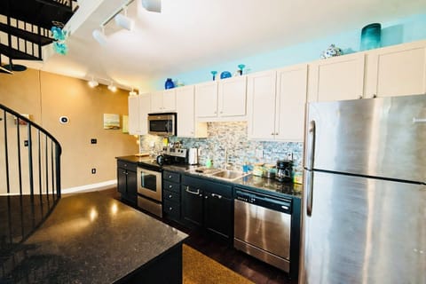 Spacious kitchen layout with ample counter space, modern lighting, and easy flow into the living area—perfect for entertaining or cooking together.