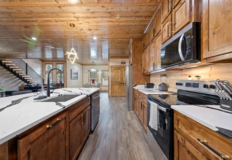 The kitchen stretches out with ample cabinetry and workspace, giving everyone plenty of room to help with cooking.