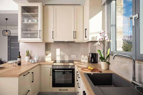 Fully equipped kitchen with oven, stovetop, fridge, and generous worktop space, ideal for preparing anything from simple breakfasts to longer family meals during your stay.