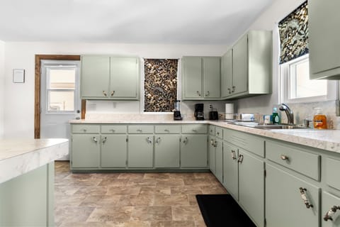 Spacious, fully equipped kitchen with ample cabinet storage.