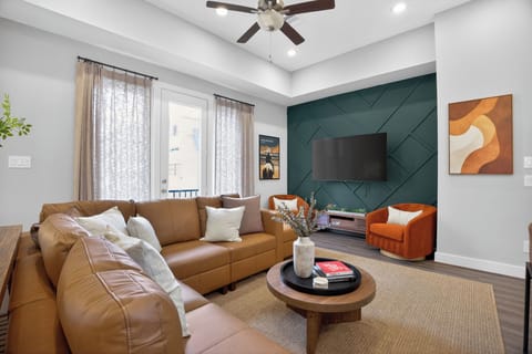 Relax in our spacious living room featuring cozy seating, a large Smart TV, and an open layout that keeps everyone connected throughout your stay.