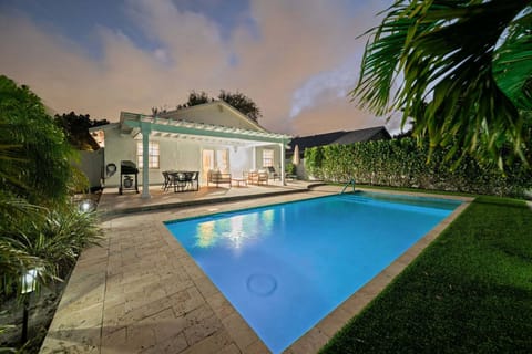 Oversized, private back yard area with shaded seating and heated pool
