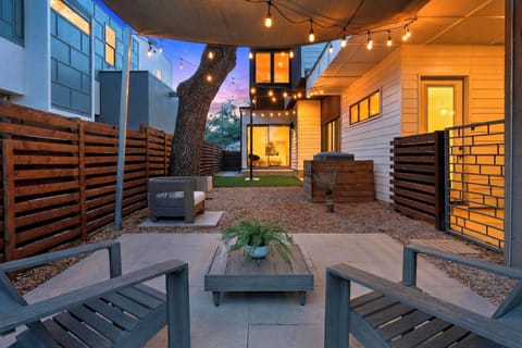 Private patio with shade sail, string lights, and lounge seating—perfect for coffee mornings and relaxed evenings outdoors.