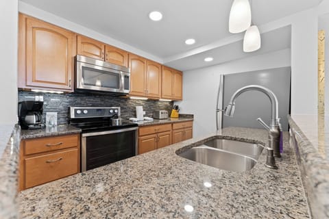 Full kitchen with stainless steel appliances.