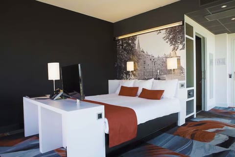 Unwind in crisp linens beneath warm, ambient bedside lighting.