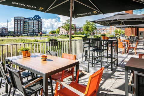 Sip drinks outdoors on the terrace with sunny neighborhood views.