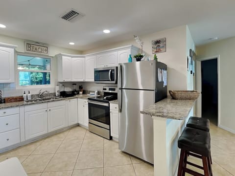 Fully Equipped Kitchen + Breakfast Bar Seating for 2