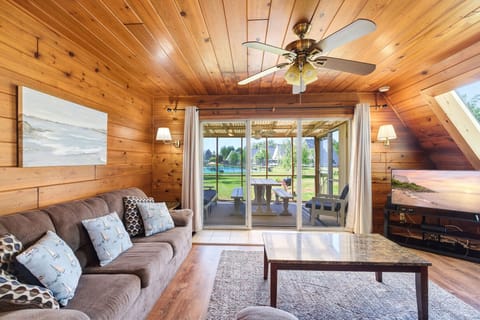 Chalet #71 living room with sliding door access to the screened porch and resort views beyond.
