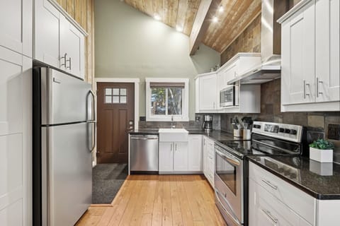Your fully equipped kitchen features stainless steel appliances, granite countertops, and charming exposed wood beams overhead for memorable meal prep.