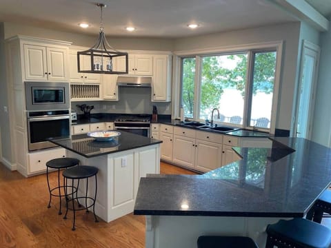 Kitchen features Gas cooktop, Double ovens, and two large islands