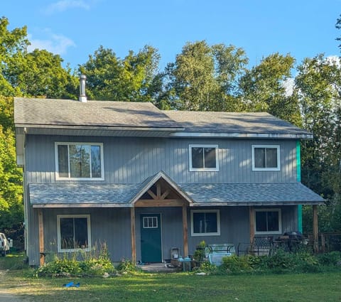 Larkwhistle Cottage – a cozy two-storey retreat surrounded by trees, offering a peaceful Bruce Peninsula getaway.
