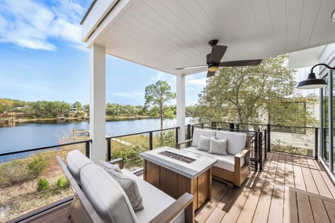 Unwind on this spacious covered deck, complete with comfortable outdoor sofas, a table with built in fire pit, and a ceiling fan to keep you cool while you enjoy the lake views