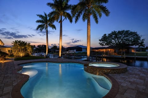 Unwind with a quiet evening swim or relaxing spa soak beside peaceful canal views as twilight settles over this private waterfront retreat.