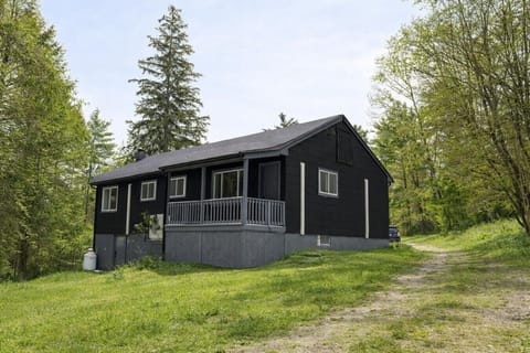 Exterior Retreat: Escape to this sleek black cabin, nestled on 6.7 lush, private acres!