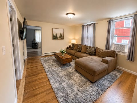 Spacious living room with sectional sofa, Smart TV and cozy seating