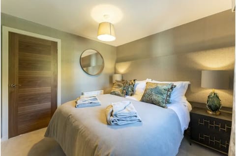 Settle into a cozy double bed with warm bedside glow.