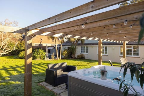 Welcome to this stylish 4-bedroom home in the peaceful village of Fishbourne, with garden and hot tub.