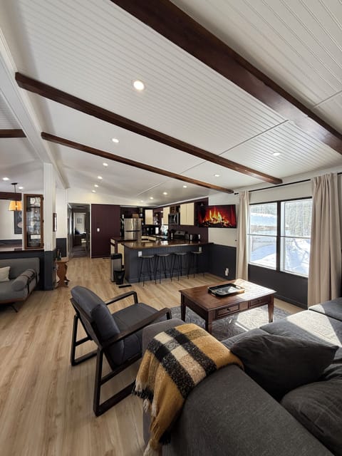 Bright open living, kitchen and dining space with plenty of seating and natural 