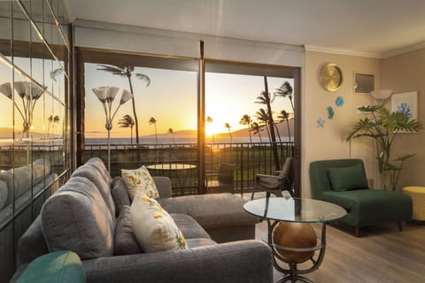 Stylish living room with lanai access and stunning ocean sunset views!