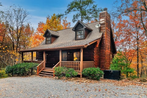 Cover photo of cabin in blazing fall foliage.