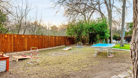 Spacious backyard with lawn games and room for outdoor activities and family fun.