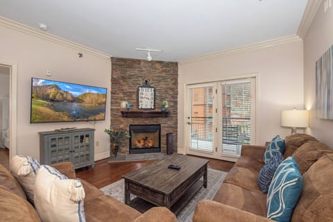 Sink into plush seating by your cozy stone fireplace, perfect for unwinding with your favorite shows after mountain adventures.