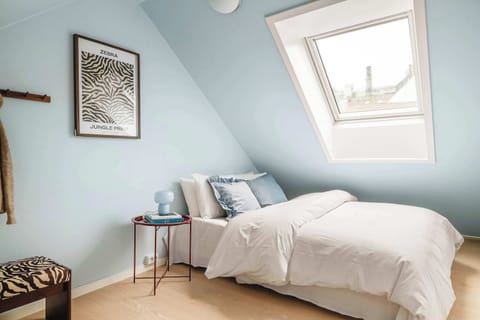 Bright and airy bedroom with a comfortable queen bed and skylight that fills the room with natural light.