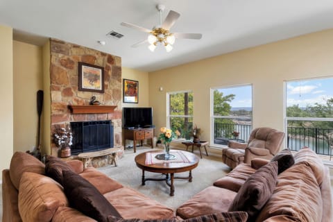 Living area with wood burning fireplace and wide screen TV