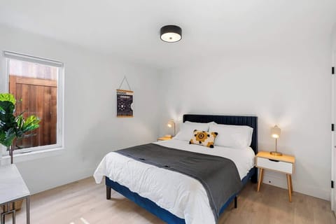 Cozy queen bedroom with stylish decor, soft linens & serene vibes—ideal for relaxing after a day of exploring.