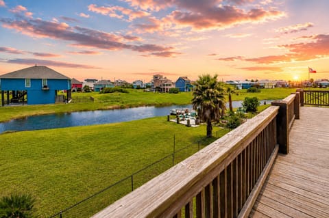 Scenic deck view from this elevated beach house in Port Bolivar, TX overlooking the peaceful Bolivar Peninsula neighborhood and nearby coastal homes.