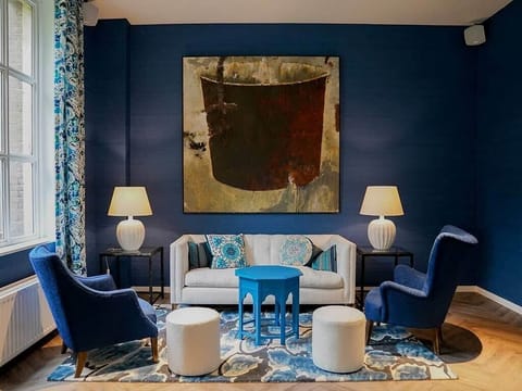 Relax under statement artwork in a curated, quiet corner.
