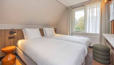 Sink into crisp bedding and wake up to natural light.