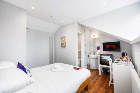 Modern guest room refreshment area with instant coffee, herbal teas and hot water kettle.