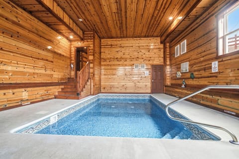 Immerse yourself in your private indoor pool sanctuary, surrounded by warm cedar walls and sparkling blue waters perfect for year-round relaxation.
