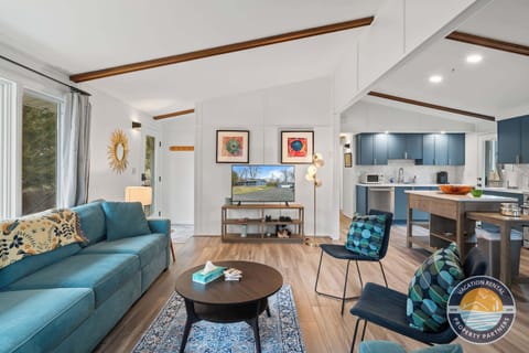 Kick back in our sun-drenched living area featuring vaulted ceilings and mid-century modern style. A family-friendly space designed for group movie nights after a day exploring the Lake Como shoreline.