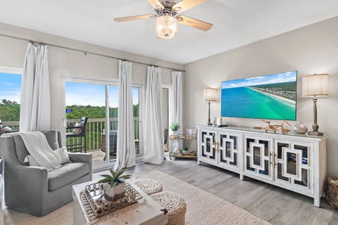 Tops'l Summit 405 has comfortable living room furniture (including a queen sleeper sofa), 65" Smart TV, Views of Tops'l State Park and Partial Views of the Gulf of Mexico