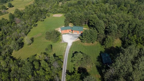 Aerial view of the home and long driveway