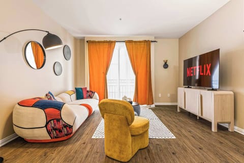 Bright and spacious living room filled with natural light, featuring comfortable seating and a relaxing atmosphere, perfect for unwinding after a long day.